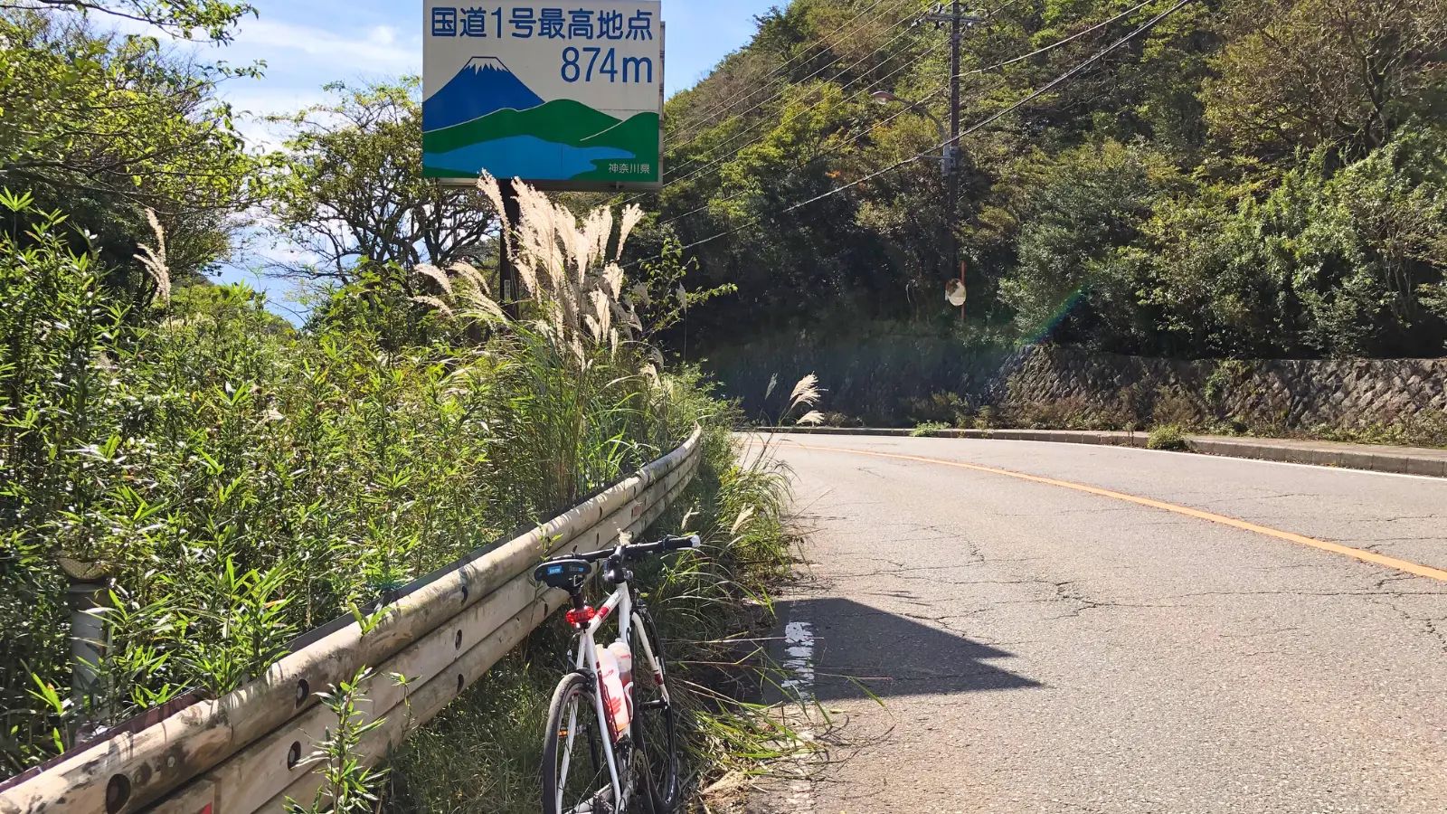 箱根の国道1号最高地点の看板とクロスバイク